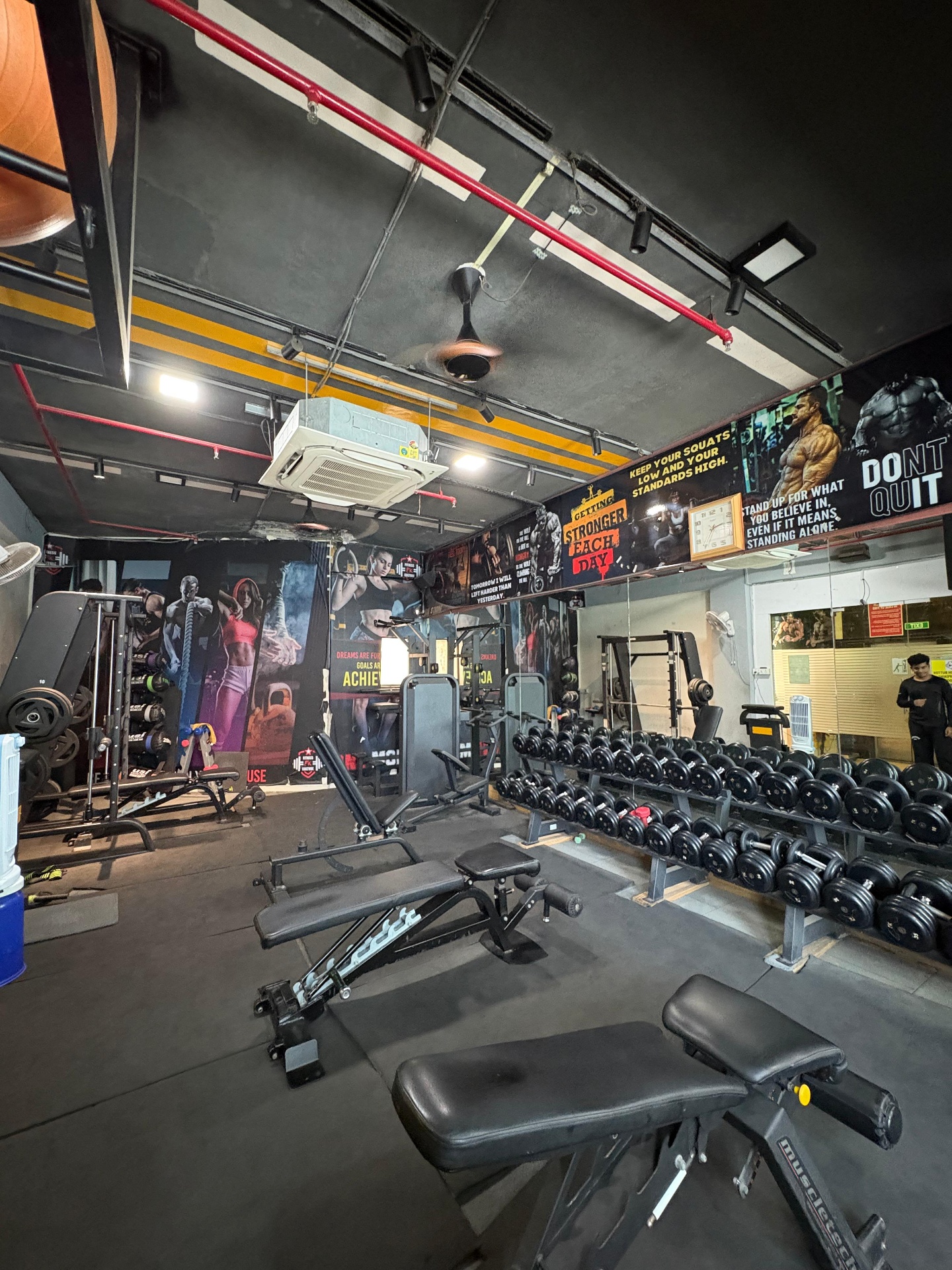 Free-weights floor with dumbbell rack and benches