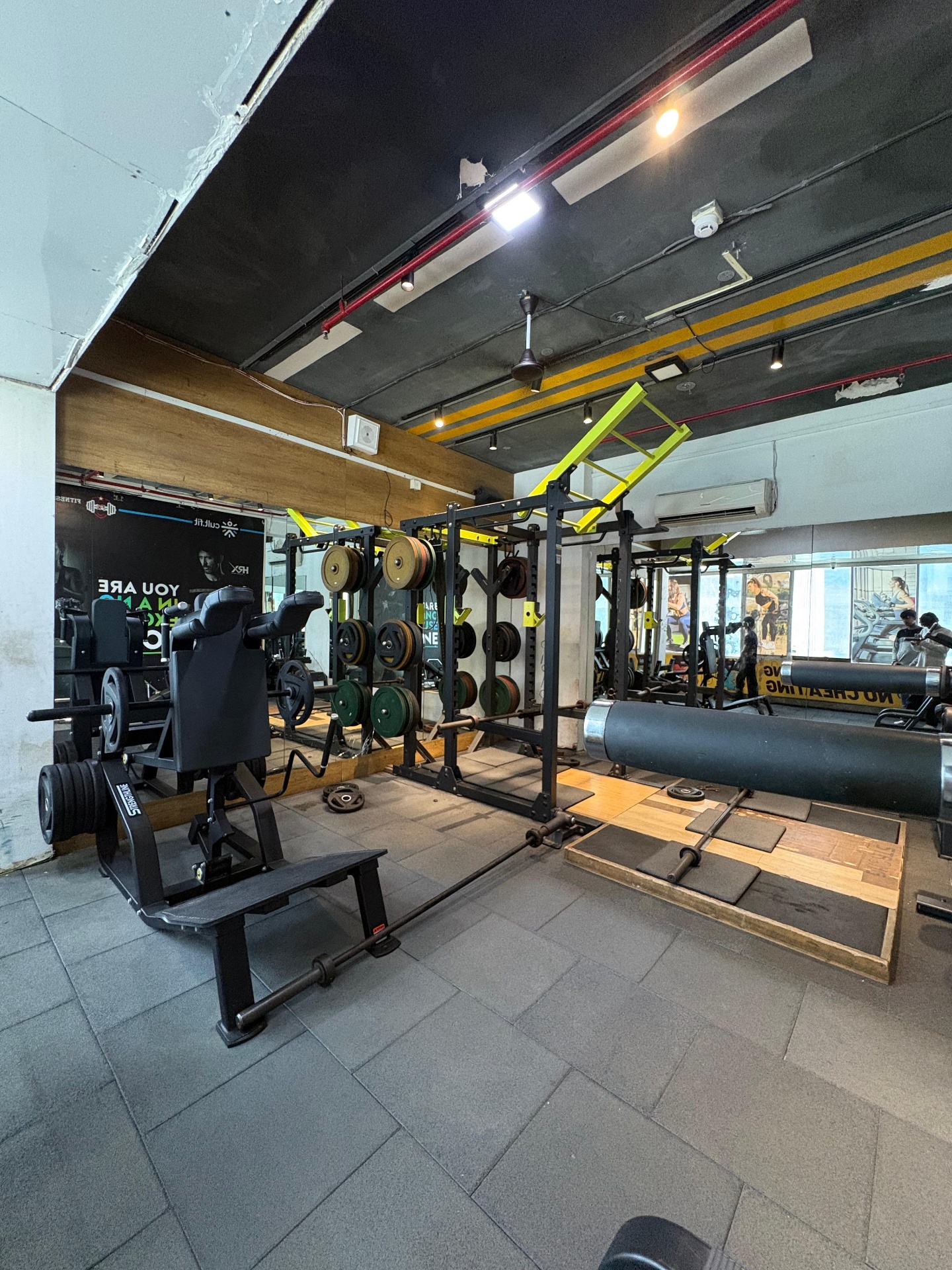 Strength training area with mirrors and dumbbells
